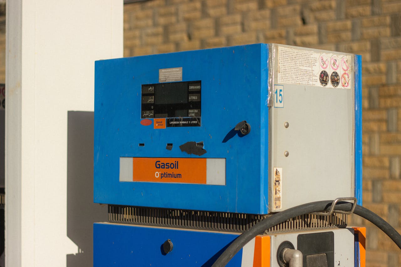 Close-up of a vintage gasoline pump with 'Gasoil Optimum' label in blue and orange.